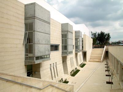 Courtyard of a blocky grey and tan stone building