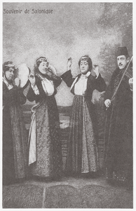 A picture labeled "Souvenir de Salonique," featuring a man playing a violin, a woman playing a drum, and two women dancing/singing