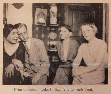 Black and white historical photograph of three women and one man seated