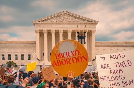  Protesters holding signs outside Supreme Court on Day Roe v Wade was overturned