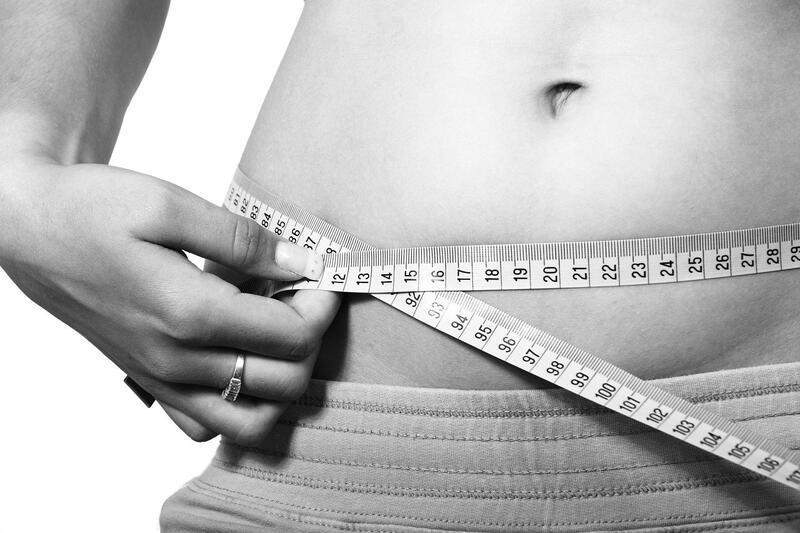 Woman measuring her stomach