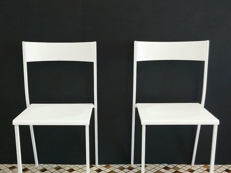 White chairs against a black wall