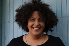 image of a woman with olive skin and dark curly hair