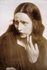 A promotional portrait of Hanna Rovina, looking concerned with her hand touching her face