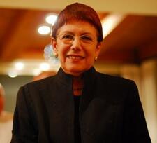 Half-portrait of Anita Shapira smiling and wearing a high neck black jacket