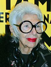 Iris Apfel smiling wearing black top and round black glasses at MIFF 2015