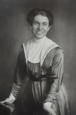 Josephine Levy-Rathenau standing and leaning against a table