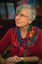 Ruth Brondy looking off camera, wearing a colorful scarf