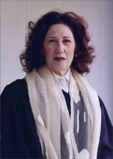 photographr of a woman wearing cantorial robes and a tallit