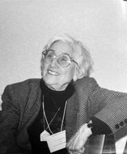 black and white photograph of a seated woman with white hair