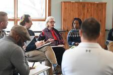 Group of people sitting in discussion circle 