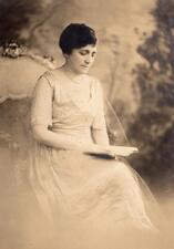 black and white historical photograph of a woman wearing a white lacey dress