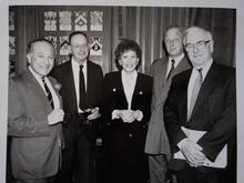 Hadassa Ben-Itto standding in between four men in suits