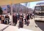 People stand near a bus preparing to evacuate unnamed Jewish community in Ukraine