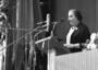 Golda Meir speaks at a podium at the 50th anniversary celebration of the Histadrut