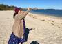 Rabbi Minna Bromberg Blowing a Shofar on the Beach