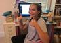 Girl seated at computer for online school during pandemic