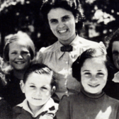 Andree Salom smiling with five young children