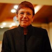 Half-portrait of Anita Shapira smiling and wearing a high neck black jacket