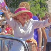 Edie Windsor wearing a hat with a pink ribbon waving to crowds at DC Pride 2017