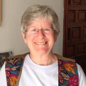 Martha Ackelsberg from the chest up smiling to the camera