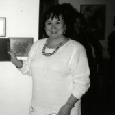 black and white photograph of a woman in a white dress