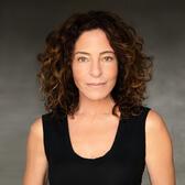 Headshot of Michelle Azar. She is a light skinned woman with brown curly hair and is wearing a black scoop neck tank top.