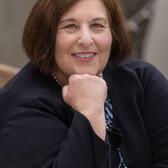 photo of a woman with her hand on a chin wearing a kippah