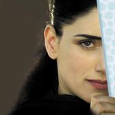 A portrait of Ronit Elkabetz with half her face obscured