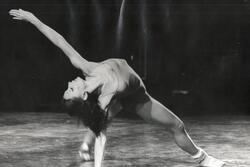 Cecilia Baram leaning back on one hand with the other extended