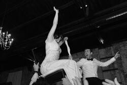 Bride and groom lifted in chairs at their wedding