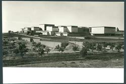 A group of flat-topped buildings on top of a hill