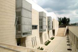 Courtyard of a blocky grey and tan stone building