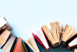 Photo of Books Arranged in an S-Shaped Pattern Across a Blue Background