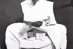 Ruth Eshel posing, draped with squares of white fabric
