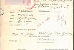 A form, printed in Polish with handwritten responses. A small black and white photo is in the upper lefthand corner and there is a red stamp.