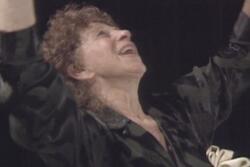 Close up of Anna Halprin raising her arms