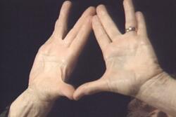 Close up of Anna Halprin's hands in the shape of the priestly blessing
