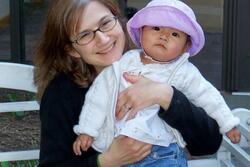 Jennifer Sartori holding her baby baby daughter