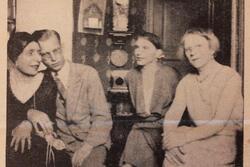 Black and white historical photograph of three women and one man seated