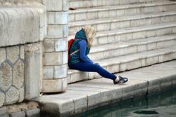 Teen Sitting on Steps of a Monument