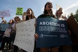 Abortion rights demonstrators hold signs outside US Supreme Court after leaked SCOTUS opinion.  