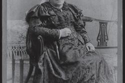 black and white historical photograph of a woman dressed in Victorian attire