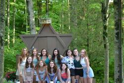 The author and her summer camp cabin posing for a photo