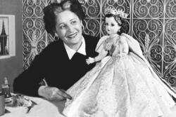 Beatrice Alexander Examining the Queen Elizabeth II Doll from the Coronation Set, 1953