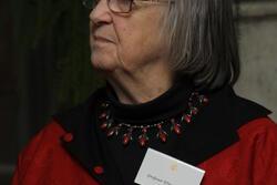 photograph of a woman with gray hair wearing a red dress