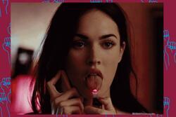Megan Fox holding a flame to her tongue with her phone held up to her ear