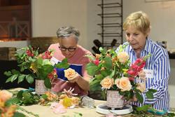 Two women arranging flowers