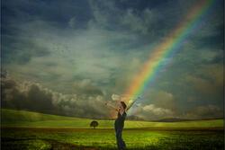 Woman in Field with Rainbow