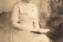 black and white historical photograph of a woman wearing a white lacey dress